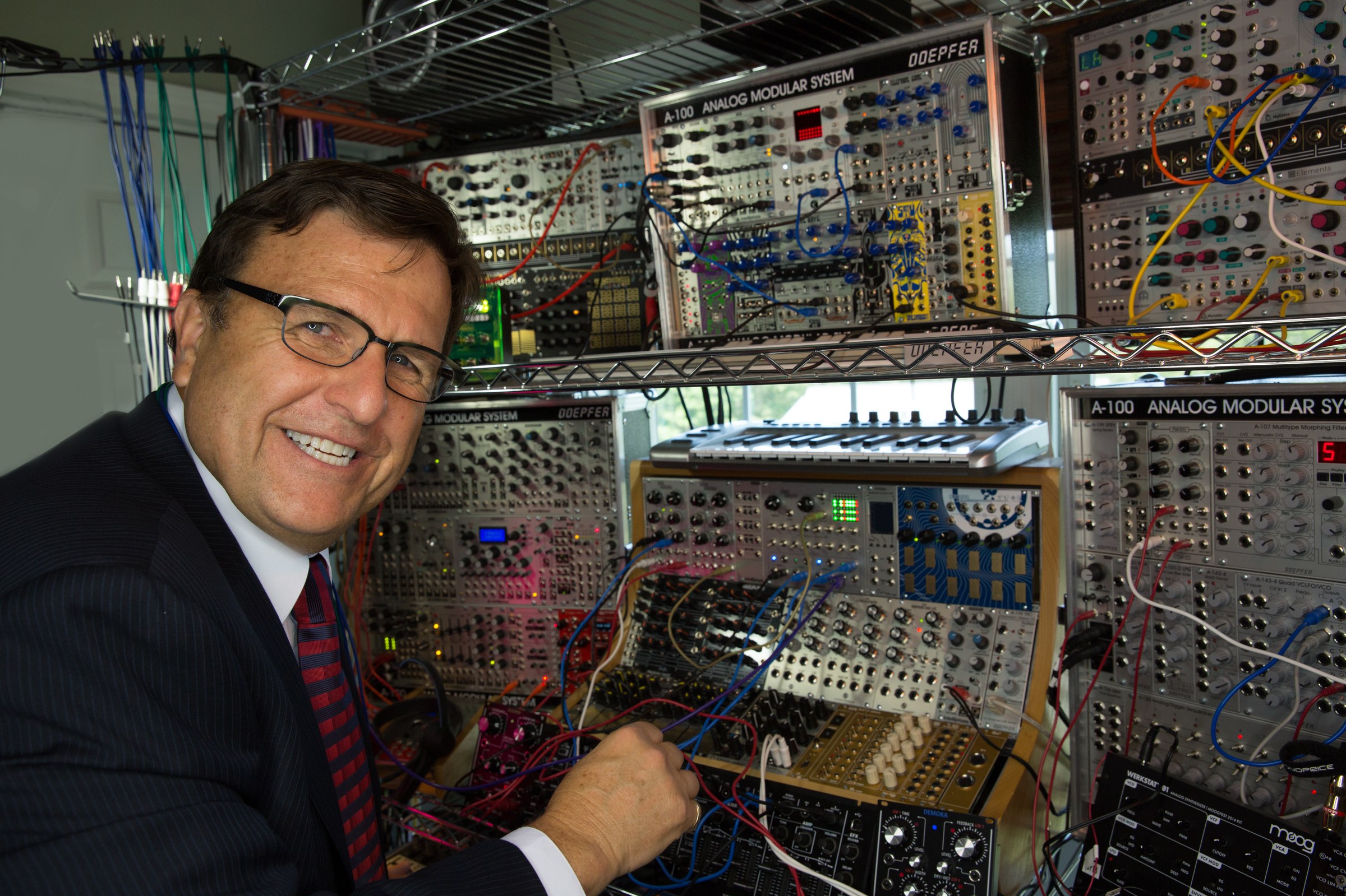 Dr. Boulanger in suit with Eurorack modular