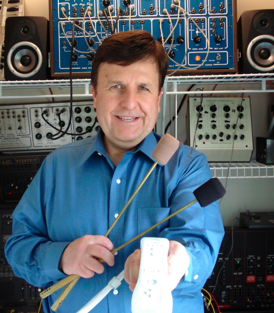 Dr. Boulanger holding Radio Baton batons and Wii remote