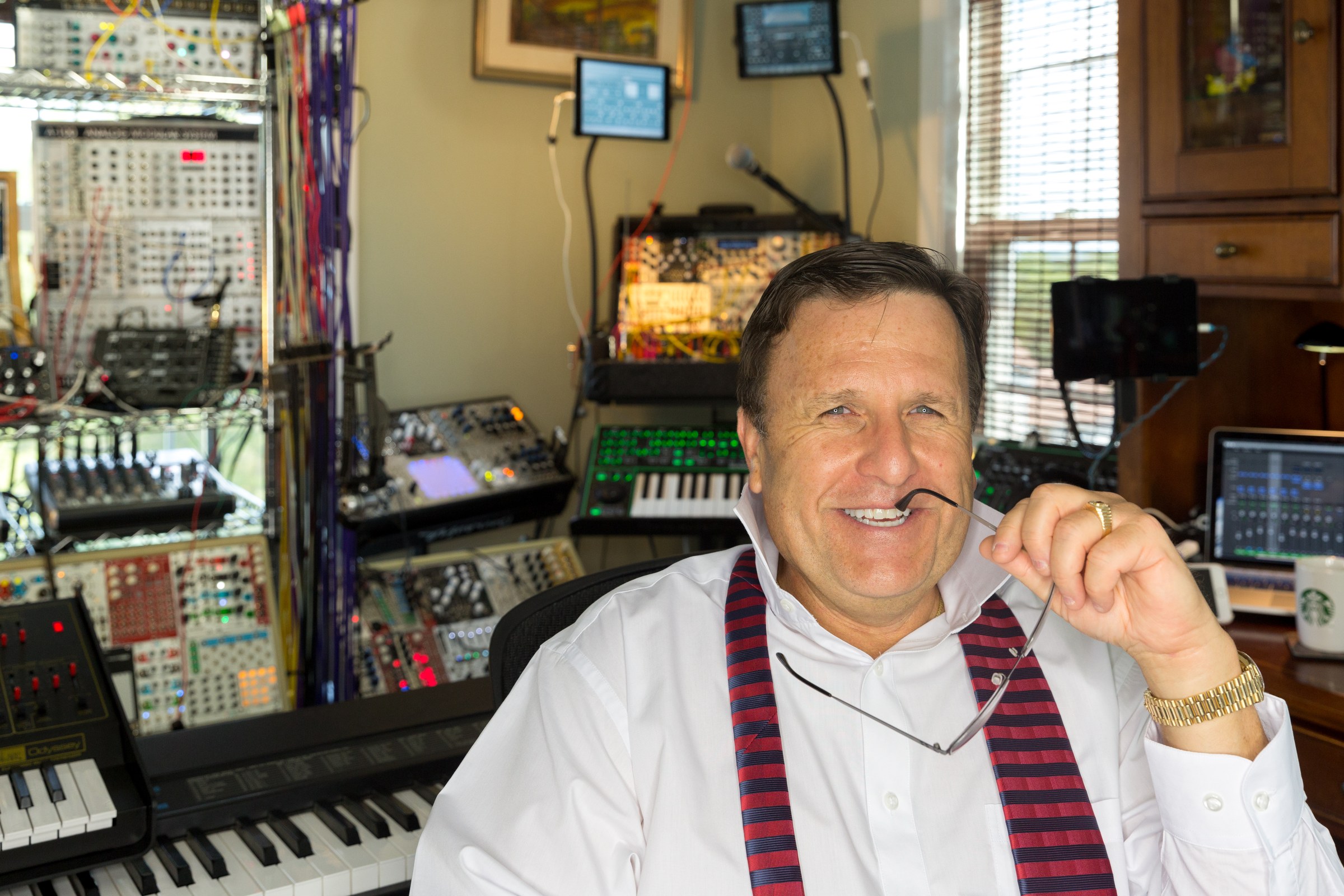 Dr. Boulanger seated in studio with glasses